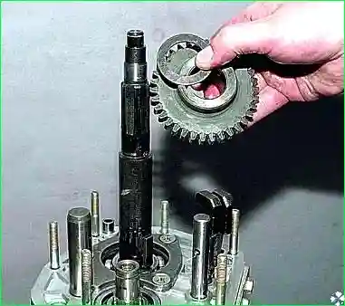 Снимаем ведомую шестерню заднего хода и пружинную шайбу