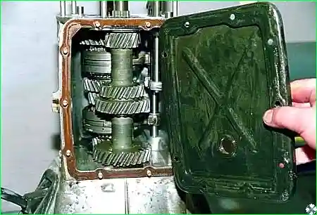 Снимаем крышку с прокладкой. Кладем коробку передач на бок